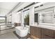 Elegant bathroom with a freestanding tub, sleek vanities, and contemporary fixtures at 12 Falling Canyon Ct, Henderson, NV 89011