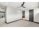 A bright bedroom with a ceiling fan, tile floors, and access to an ensuite bathroom at 12 Falling Canyon Ct, Henderson, NV 89011