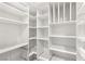 Walk-in closet featuring custom white shelving, ample storage space, and wire baskets at 12 Falling Canyon Ct, Henderson, NV 89011