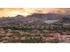 Scenic view of upscale community nestled against desert mountains at sunset at 12 Falling Canyon Ct, Henderson, NV 89011