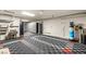 Spacious garage with a checkered floor, utility sink, storage cabinets and water treatment equipment at 12 Falling Canyon Ct, Henderson, NV 89011
