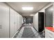 Large garage featuring checkered floors, overhead lighting, and rows of built-in storage cabinets at 12 Falling Canyon Ct, Henderson, NV 89011