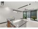 Modern kitchen island with seating, stainless steel appliances, and an outdoor view at 12 Falling Canyon Ct, Henderson, NV 89011