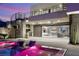 Expansive outdoor living space with a sleek pool, covered grill, and seamless transition to the home's interior at 12 Falling Canyon Ct, Henderson, NV 89011