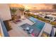Luxurious pool and spa combo surrounded by modern landscaping with views of the neighborhood and city at 12 Falling Canyon Ct, Henderson, NV 89011