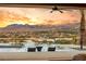 Stunning infinity pool overlooking mountains at sunset provides an opulent outdoor living experience at 12 Falling Canyon Ct, Henderson, NV 89011
