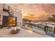 Rooftop terrace featuring a fire pit, spiral staircase, and panoramic views of the city skyline and sunset at 12 Falling Canyon Ct, Henderson, NV 89011