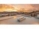 Relaxing rooftop terrace with a modern fire pit, offering breathtaking views of the surrounding landscape and sunset at 12 Falling Canyon Ct, Henderson, NV 89011