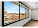 Expansive view from a large window with hardwood floors, showcasing the surrounding hills and neighborhood at 12 Falling Canyon Ct, Henderson, NV 89011