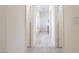 Hallway view of bathroom with tile flooring, double doors, and shower at 1212 Equator Ave, North Las Vegas, NV 89032