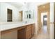 Bathroom vanity with a large mirror and wood cabinets at 1212 Equator Ave, North Las Vegas, NV 89032