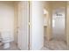 Toilet area leading to bright bedroom with ceiling fan and open closet at 1212 Equator Ave, North Las Vegas, NV 89032