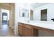 Hallway bathroom vanity with mirror and lighting, featuring a tile floor at 1212 Equator Ave, North Las Vegas, NV 89032