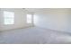 Spacious carpeted bedroom with bright natural light from two windows at 1212 Equator Ave, North Las Vegas, NV 89032