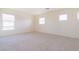 Spacious carpeted bedroom with bright natural light from three windows at 1212 Equator Ave, North Las Vegas, NV 89032