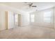 Carpeted bedroom with multiple windows and a view into an adjacent room at 1212 Equator Ave, North Las Vegas, NV 89032