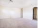 Spacious carpeted bedroom with an archway entrance to another room at 1212 Equator Ave, North Las Vegas, NV 89032