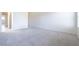 Spacious carpeted bedroom with an doorway to another room and bright natural light from a window at 1212 Equator Ave, North Las Vegas, NV 89032