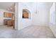 Tile floor view of dining room and open kitchen with hanging chandelier at 1212 Equator Ave, North Las Vegas, NV 89032