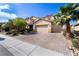 Charming two-story home boasts a paved driveway, mature palm tree, and a spacious three-car garage at 1212 Equator Ave, North Las Vegas, NV 89032