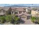 Stunning two-story home with a well-manicured lawn, mature trees, and a three-car garage at 1212 Equator Ave, North Las Vegas, NV 89032