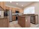 Charming kitchen featuring stainless steel appliances, granite countertops, tile flooring, and a functional center island at 1212 Equator Ave, North Las Vegas, NV 89032