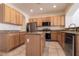 Charming kitchen featuring stainless steel appliances, granite countertops, tile flooring, and a functional center island at 1212 Equator Ave, North Las Vegas, NV 89032