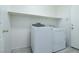 Laundry room with appliances and overhead shelving at 1212 Equator Ave, North Las Vegas, NV 89032