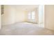 Bright open-concept living room with neutral carpet and multiple windows at 1212 Equator Ave, North Las Vegas, NV 89032