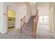 Bright and airy staircase with access to a laundry room and the second floor of the home at 1212 Equator Ave, North Las Vegas, NV 89032