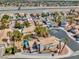 Expansive aerial view of a well-maintained home, showcasing a private pool and lush landscaping in a quiet neighborhood at 125 Firecreek Cir, Las Vegas, NV 89107