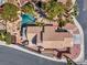 Aerial view showcasing the tile roof, pool, waterfall feature, patio, and mature landscaping at 125 Firecreek Cir, Las Vegas, NV 89107