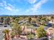 Picturesque aerial view of a lovely neighborhood with lush trees, highlighting a home with a private pool and spa at 125 Firecreek Cir, Las Vegas, NV 89107