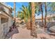 The backyard features mature landscaping, a rock waterfall feature, and low-maintenance landscaping at 125 Firecreek Cir, Las Vegas, NV 89107