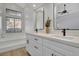 Modern bathroom featuring a double vanity and a bathtub with a view at 125 Firecreek Cir, Las Vegas, NV 89107