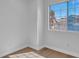 Bright bedroom with wood-style flooring and a view of mature trees at 125 Firecreek Cir, Las Vegas, NV 89107
