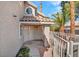 Inviting front entry featuring double doors, unique round window, and an attractive tiled porch at 125 Firecreek Cir, Las Vegas, NV 89107