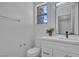 Beautifully updated half bathroom featuring modern vanity, stylish mirror and bright natural light at 125 Firecreek Cir, Las Vegas, NV 89107