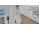 Upstairs hallway featuring white railings and wood-style flooring at 125 Firecreek Cir, Las Vegas, NV 89107