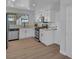 Stylish updated kitchen featuring white cabinets, stainless steel appliances and hardwood floors at 125 Firecreek Cir, Las Vegas, NV 89107
