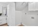 Laundry room featuring storage cabinets and a nearby half bath with granite countertop at 125 Firecreek Cir, Las Vegas, NV 89107