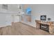 Spacious living room boasts wood-look floors, a cozy stone fireplace, and soaring ceilings with large windows at 125 Firecreek Cir, Las Vegas, NV 89107