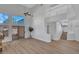 Open-concept living room with wood-look floors, staircase, and sliding glass door to the back yard at 125 Firecreek Cir, Las Vegas, NV 89107