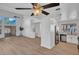 Bright, open-concept living room with modern flooring flowing into the updated kitchen featuring stainless steel appliances at 125 Firecreek Cir, Las Vegas, NV 89107