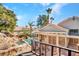 Upper view of backyard with custom rock waterfall, grotto, patio, mature landscaping, and desert scape at 125 Firecreek Cir, Las Vegas, NV 89107