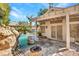 Backyard pool area features a custom rock waterfall, spa, and covered patio with flagstone at 125 Firecreek Cir, Las Vegas, NV 89107