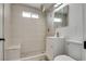 Updated bathroom featuring a tiled shower with a bench and modern vanity at 1400 Cottonwood Pl, Las Vegas, NV 89104