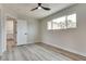 Bedroom with bright neutral walls and gray wood floors, featuring a large window at 1400 Cottonwood Pl, Las Vegas, NV 89104