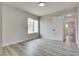 Bright bedroom features natural light from a window, light walls, and wood-look floors at 1400 Cottonwood Pl, Las Vegas, NV 89104