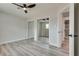 Bedroom with gray wood floors, closet with mirrored sliding doors, and neutral walls at 1400 Cottonwood Pl, Las Vegas, NV 89104